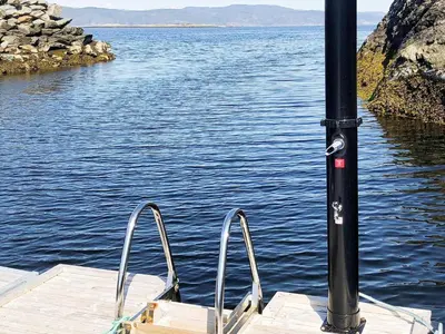 a boat with two metal rails on a body of water at 10 person holiday home in INDERØY-By Traum in Kjerkenesvåg