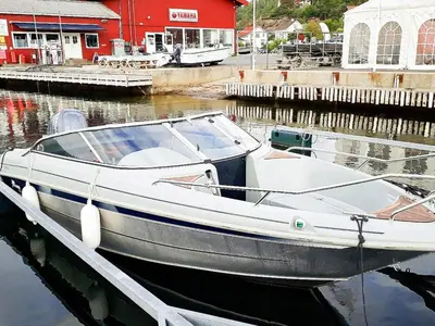 a boat is docked at a dock in the water at 10 person holiday home in INDERØY-By Traum in Kjerkenesvåg