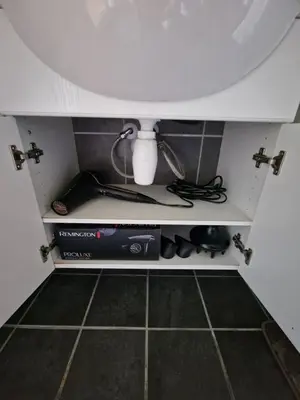 a shelf in a kitchen with a sink at Cozy apartment close to Trondheim City in Melhus