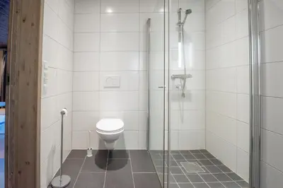 a bathroom with a toilet and a glass shower at Trysiltunet 10B in Trysil