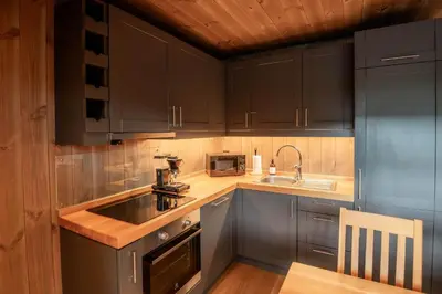 a kitchen with gray cabinets and a sink at Trysiltunet 10B in Trysil