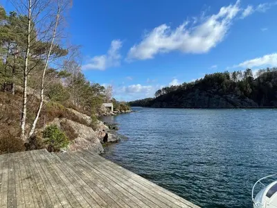 a view of a river from a wooden dock at 6 person holiday home in Rubbestadneset in Rubbestadneset