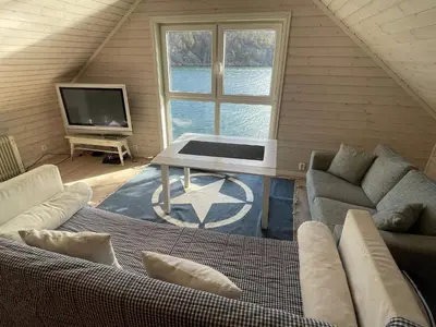 a living room with a couch and a table and a tv at 6 person holiday home in Rubbestadneset in Rubbestadneset