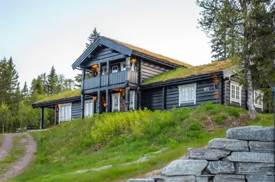 a log cabin with a grass roof on a hill at Trysilfjellet Nord 901 in Trysil