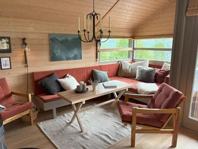 a living room with a couch and a table at Cosy cabin in Hemsedal with ski in-ski out to Solheisen in Hemsedal