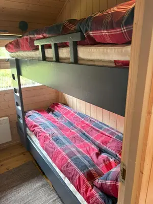 a couple of bunk beds in a room at Cosy cabin in Hemsedal with ski in-ski out to Solheisen in Hemsedal