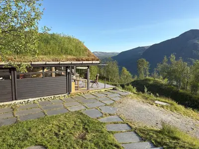 a building with a grass roof and a walkway at Cosy cabin in Hemsedal with ski in-ski out to Solheisen in Hemsedal