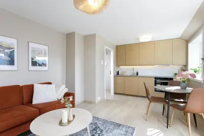 a living room with a couch and a table at Fjord Vista - Top floor apartment in Ålesund in Ålesund