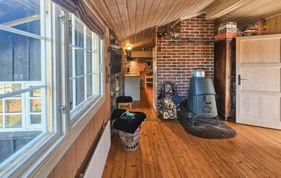 a living room with a stove and a brick wall at 3 Bedroom Lovely Home In Dagali in Dagali