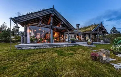 a large wooden house with a roof at Awesome Home In Flesberg With Sauna in Flesberg
