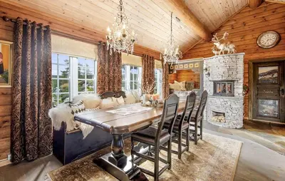 a dining room with a table and a fireplace at Awesome Home In Flesberg With Sauna in Flesberg