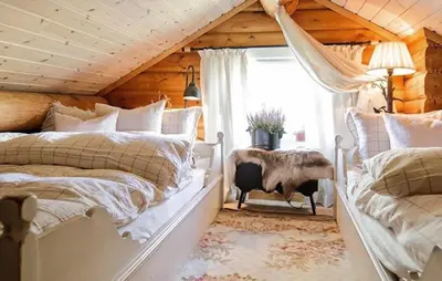 two beds in a room with wooden ceilings at Awesome Home In Flesberg With Sauna in Flesberg