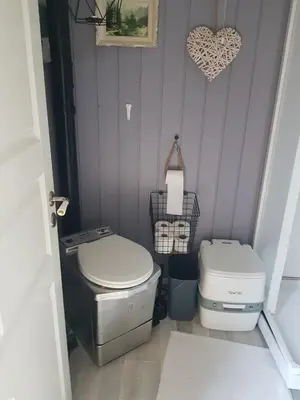 a bathroom with a toilet and a heart on the wall at Idyllic cottage with a view, close to Gardermoen Airport in Hurdal