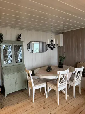 a dining room with a table and chairs at Idyllic cottage with a view, close to Gardermoen Airport in Hurdal