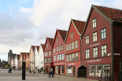 a row of redbered buildings on a street at Charming apt in the centre of Bergen in Bergen