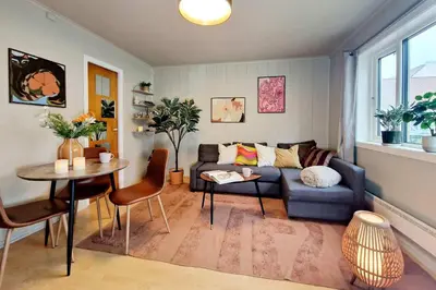a living room with a couch and a table at Historic retreat in the middle of town in Bergen