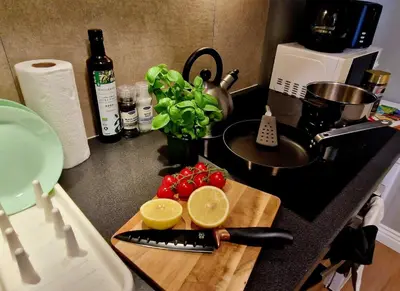 a kitchen counter with a cutting board with a knife at Historic retreat in the middle of town in Bergen