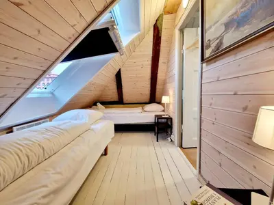 a small room with two beds and an attic at Historic townhouse - 2 baths 3 floors 100 percent charm in Bergen