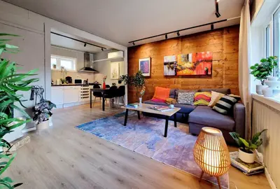 a living room with a couch and a table at Historic townhouse - 2 baths 3 floors 100 percent charm in Bergen