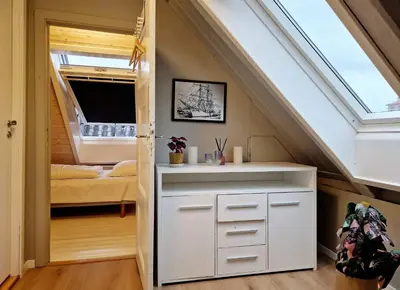 a small room with a bed and a window at Historic charm in the heart of Bergen in Bergen