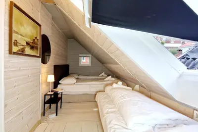 a room with two beds and a staircase at Historic charm in the heart of Bergen in Bergen