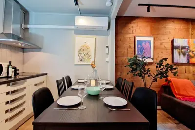a dining room with a table and a kitchen at Historic charm in the heart of Bergen in Bergen