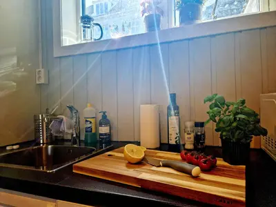 a kitchen counter with a cutting board and a knife at Historic charm in the heart of Bergen in Bergen