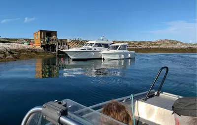 two boats are docked in a body of water at Nice Home In Sauøya With House Sea View