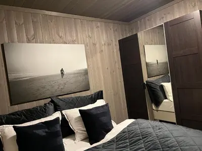 a bedroom with a bed with a picture on the wall at Brand new house close 2 Skiresort in Hemsedal