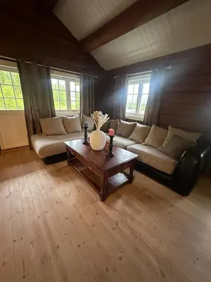 a living room with a couch and a table at Peaceful cabin with secluded location in Ål