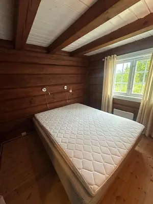 a bedroom with a mattress in a room with a window at Peaceful cabin with secluded location in Ål