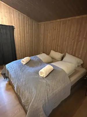 a bedroom with a bed with two towels on it at Cozy little cottage for rent in Oppheim in Ål