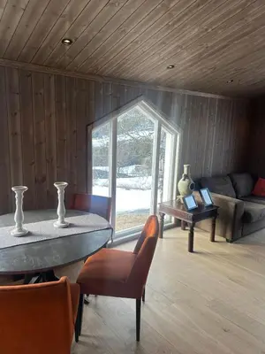 a living room with a table and a couch at Cozy little cottage for rent in Oppheim in Ål