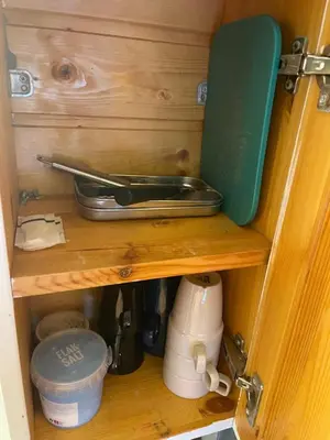 a wooden drawer with a knife and other kitchen utensils at The top half of a house with sea view in Steinkjer