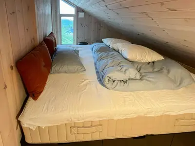 a couple of beds in a room at Architect-Designed Cabin With Views Of Sigdal in Eggedal