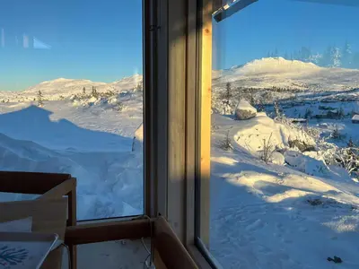a window with a view of a snow covered mountain at Architect-Designed Cabin With Views Of Sigdal in Eggedal