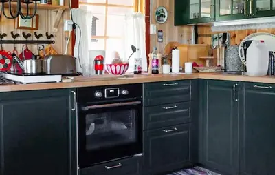 a kitchen with green cabinets and a black oven at 3 Bedroom Beautiful Home In Tynset in Tynset