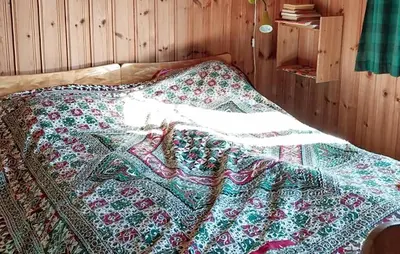 a bed with a quilt on it in a room at 3 Bedroom Beautiful Home In Tynset in Tynset