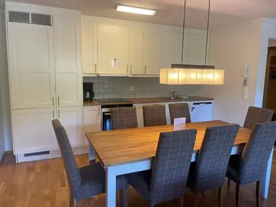 a kitchen with a wooden table and chairs at Stor Leilighet Med 4 Soverom Og 2 Bad in Beitostøl