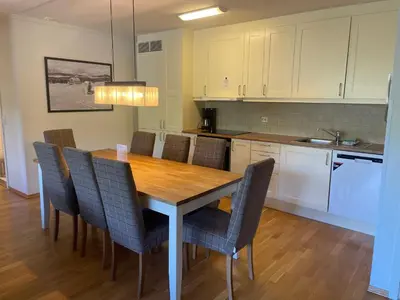a kitchen with a wooden table and chairs at Stor Leilighet Med 4 Soverom Og 2 Bad in Beitostøl