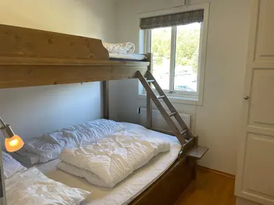 a bedroom with two bunk beds and a window at Stor Leilighet Med 4 Soverom Og 2 Bad in Beitostøl