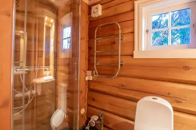 a bathroom with a shower and a toilet in it at Trysilfjellet Nord 901 stabur in Trysil