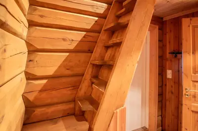 a staircase in a log cabin with wooden walls at Trysilfjellet Nord 901 stabur in Trysil