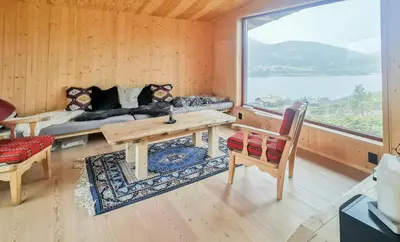 a living room with a table and a couch and a window at Modern Lines And Coziness In Hemsedal in Hemsedal