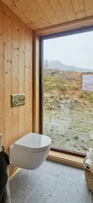 a bathroom with a large window and a white tub at Modern Lines And Coziness In Hemsedal in Hemsedal
