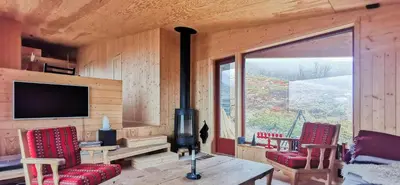 a living room with a television and a table and chairs at Modern Lines And Coziness In Hemsedal in Hemsedal