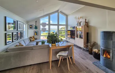 a living room with a couch and a fireplace at Beautiful Home In Bjørøyhamn With House Sea View in Nord Bjørøy