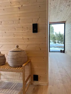 a room with a wooden wall with a bench and a window at New cabin in beautiful surroundings in Oppdal