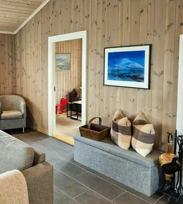 a living room with a couch and a picture on the wall at Mountain Gem With Ski In And Out At Golsfjellet in Gol