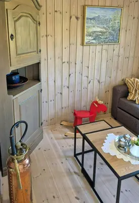 a living room with a couch and a table at Mountain Gem With Ski In And Out At Golsfjellet in Gol
